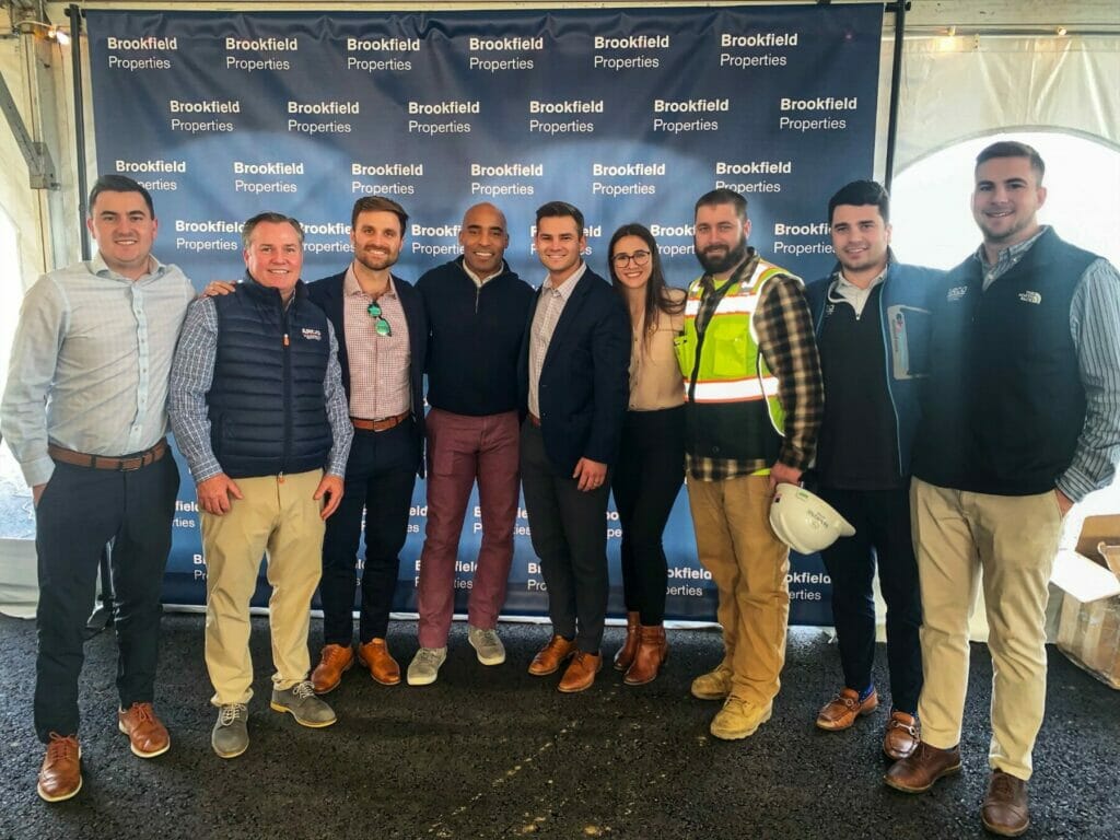 Group photo of ARCO team with Tiki Barber NFL Football Stadium Design Build Construction Company | ARCO DB | ARCO Design Build | ARCO Design/Build