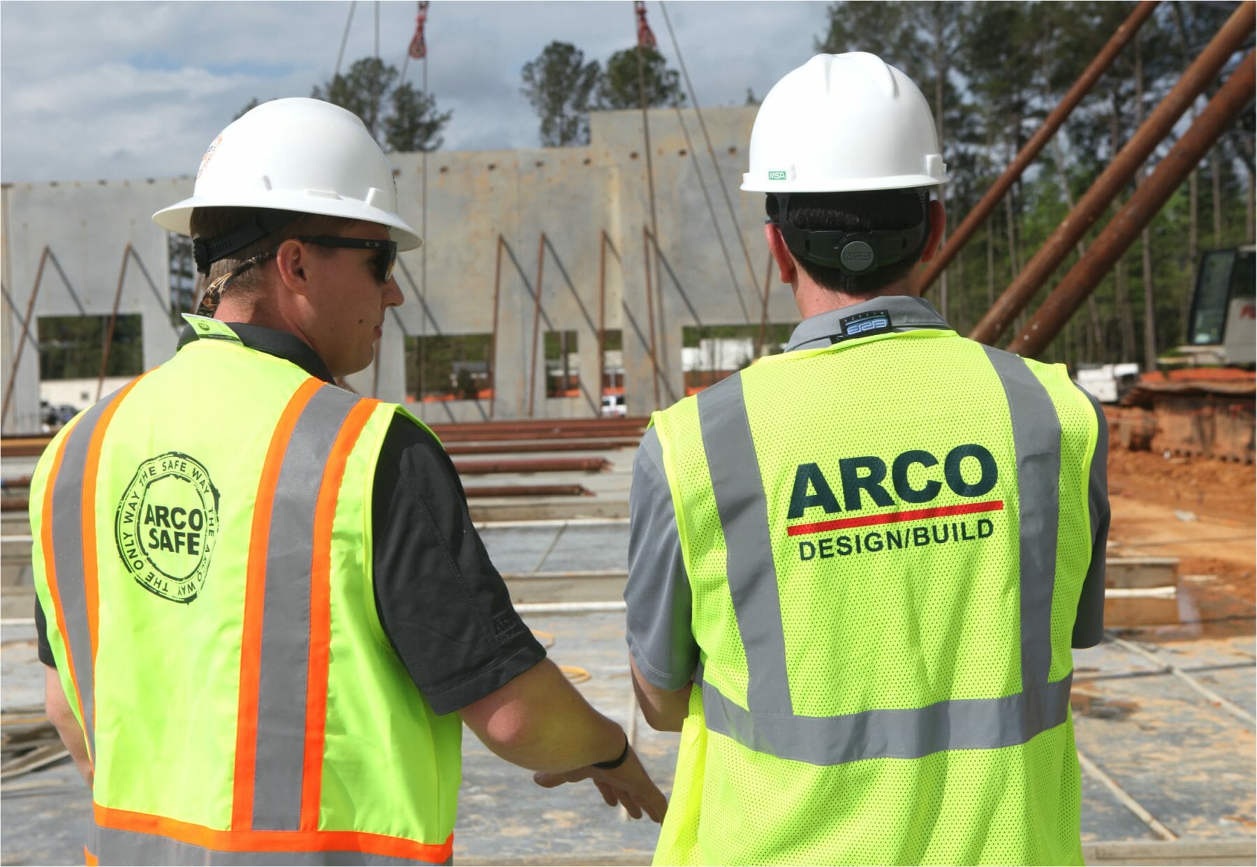 ARCO Design/Build construction photo - workers wearing safety vests and hard hats.