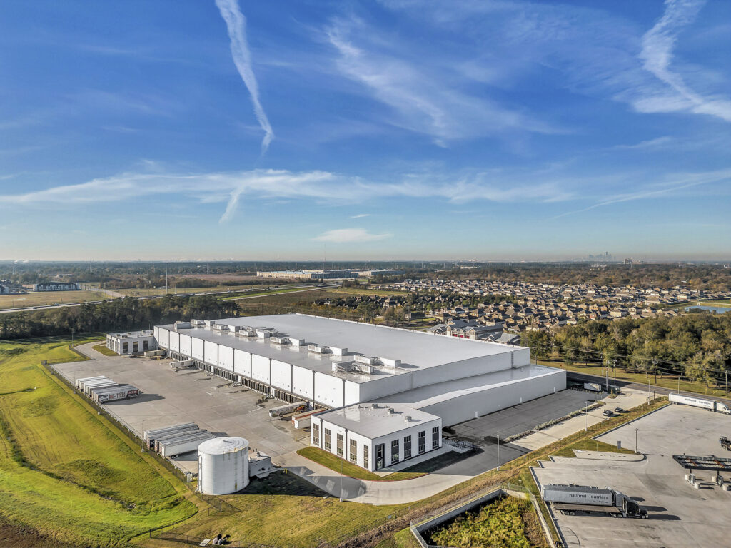 Aerial View of Industrial Warehouse - Aerial shot of an industrial facility with surrounding infrastructure.