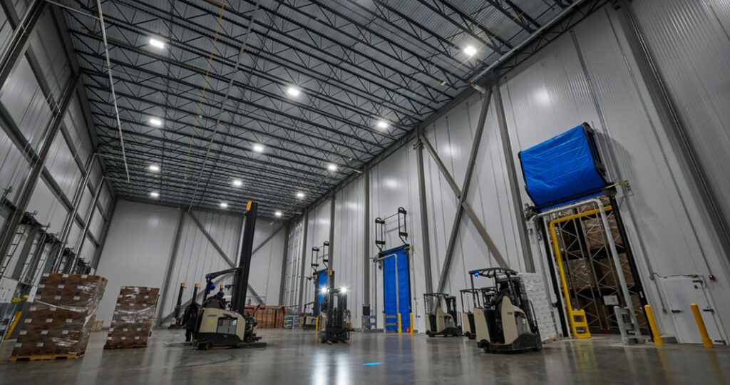 Cold storage facility room showing a few forklifts and pallets