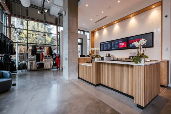 Barry's fuel bar and retail floor with polished concrete and a fluted wood service counter